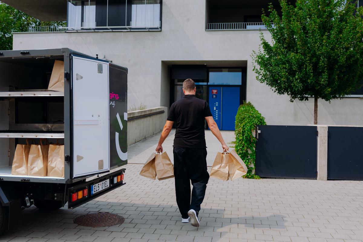 Courier delivering groceries from a Battswap van